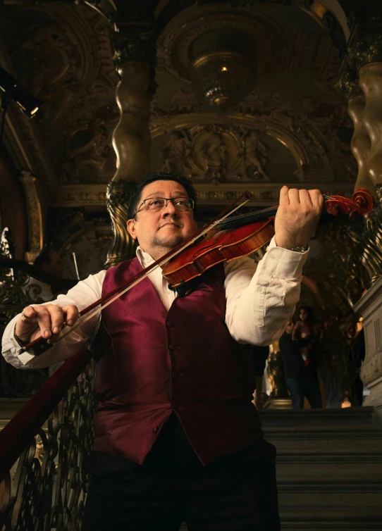 a man with a violin is standing on the stairs