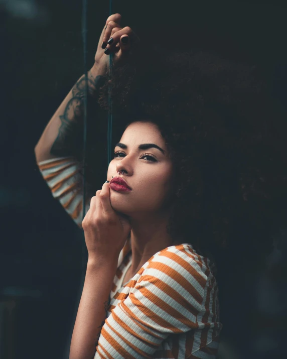 a woman in striped shirt posing for a po