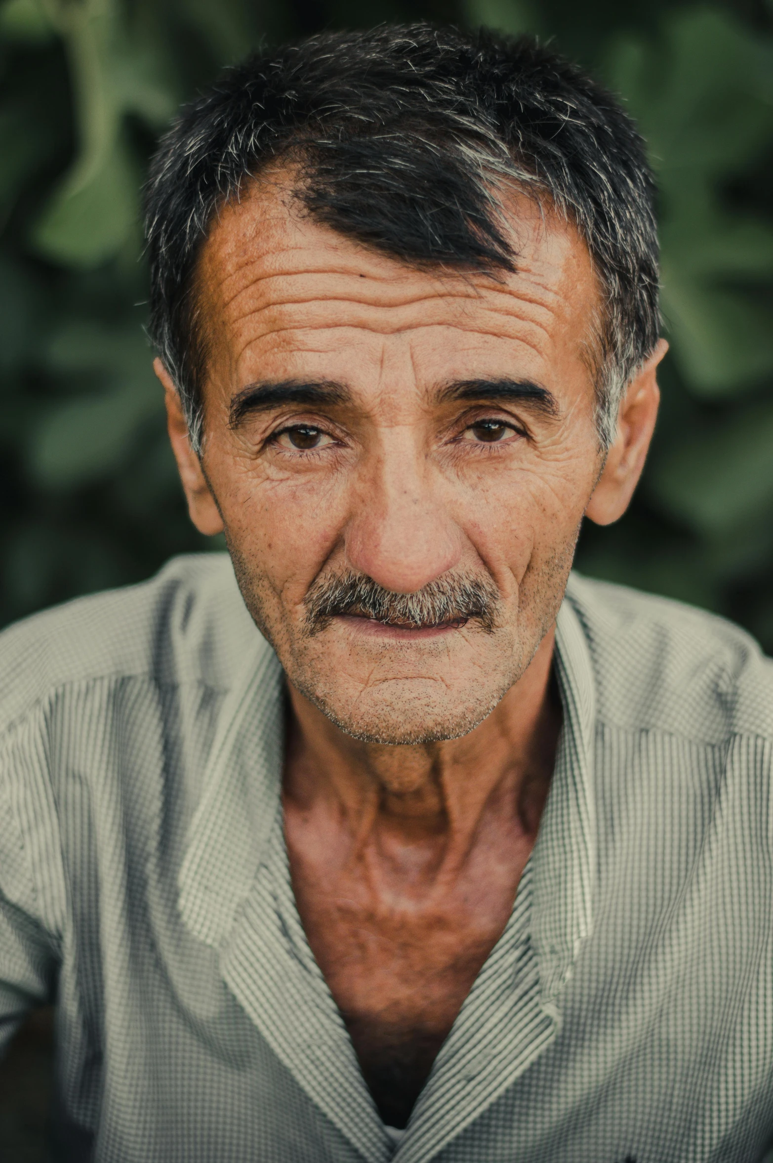 a very old man with a mustache staring at soing