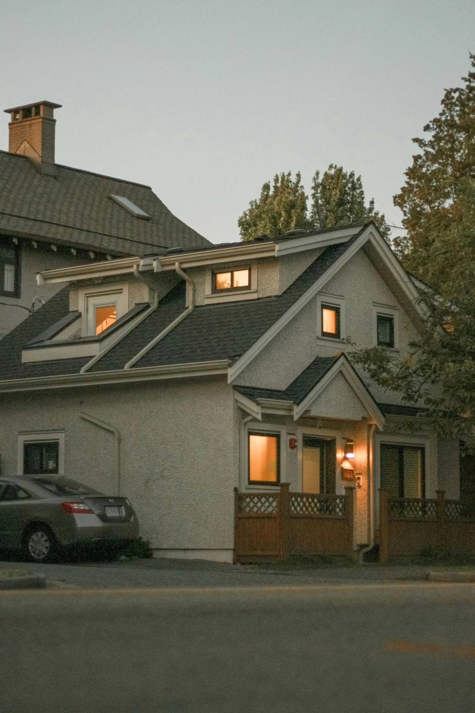 a house at sunset with the driveway lit