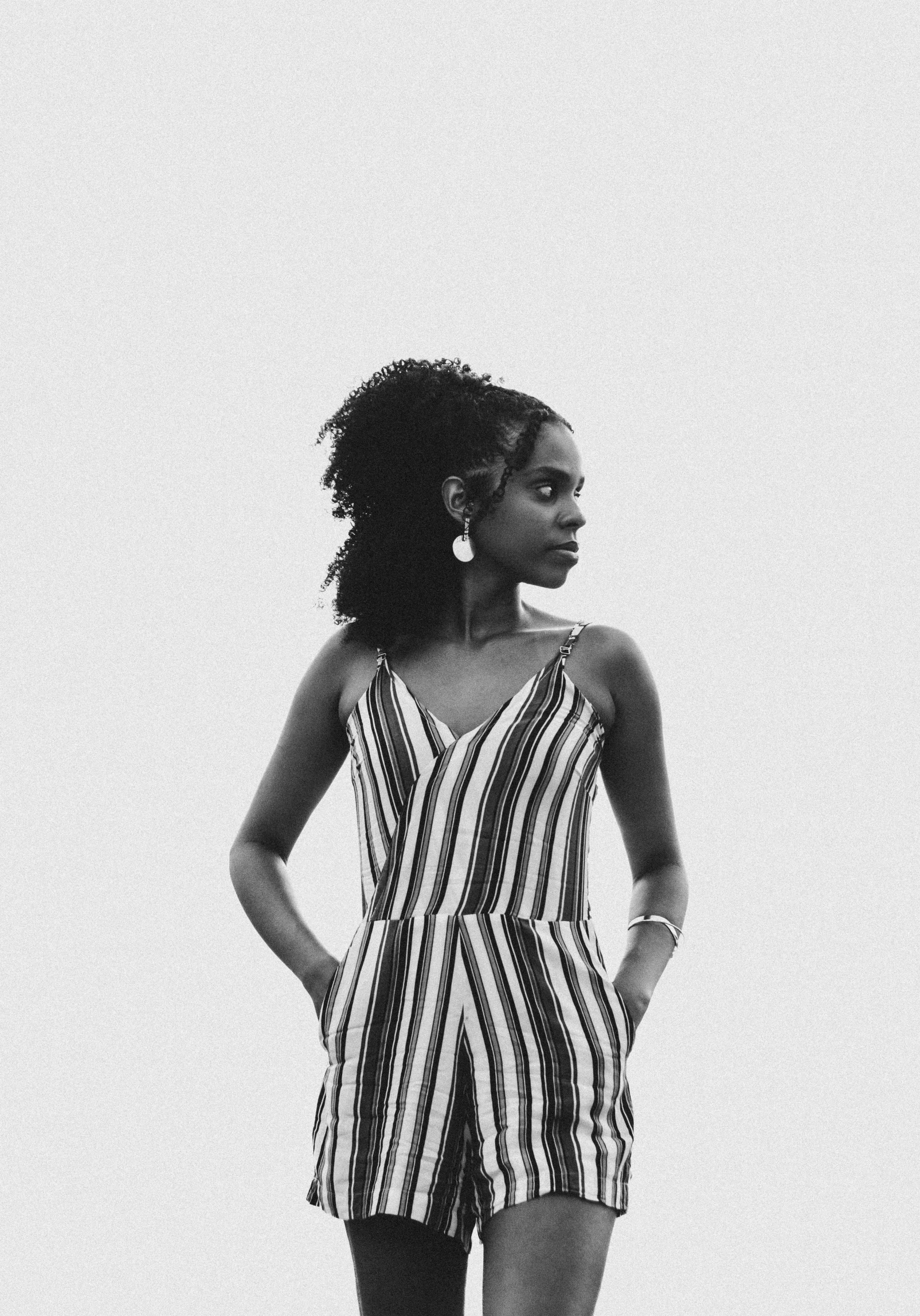 a woman in black and white striped clothing standing