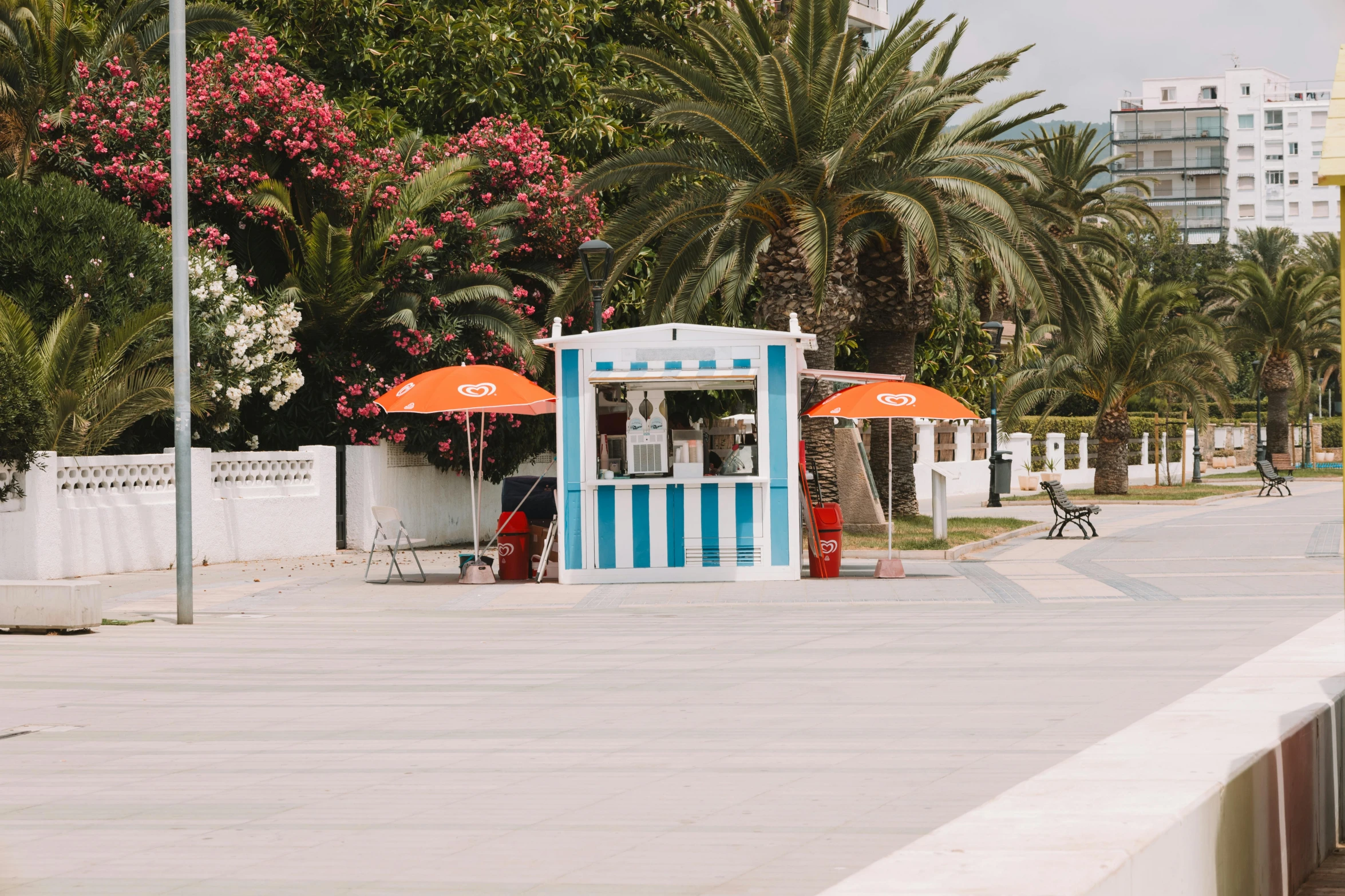 a food cart is selling drinks next to trees