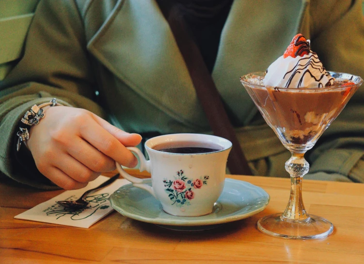 a cup of coffee with an ice cream scoop