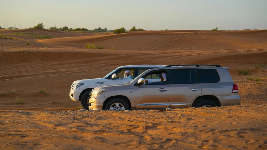 an off road vehicle in the desert with two passengers