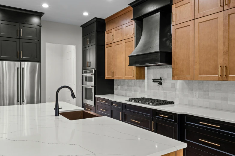 a kitchen with black cabinets and white counters