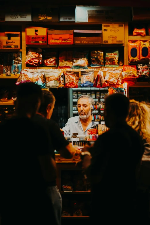 people standing around in a store with a po on the wall