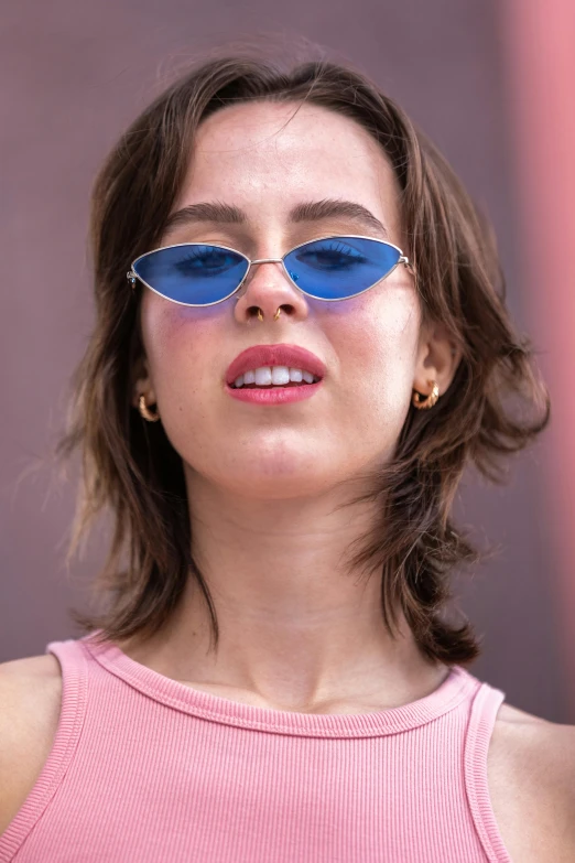 a woman wearing sunglasses stares upwards