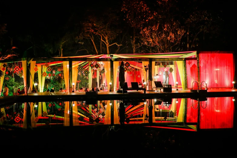 a colorful covered stage is lit up at night