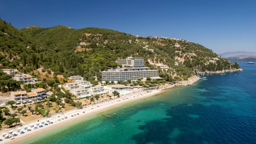 the resort area next to the ocean is dotted by lush greenery