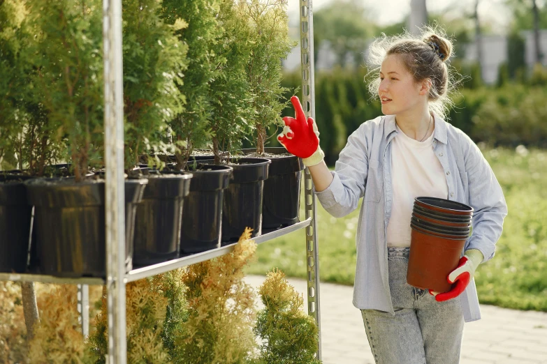 a woman walking past a bunch of trees