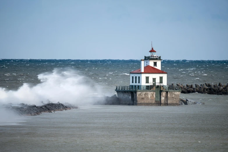 a lighthouse on a rocky beach near the ocean