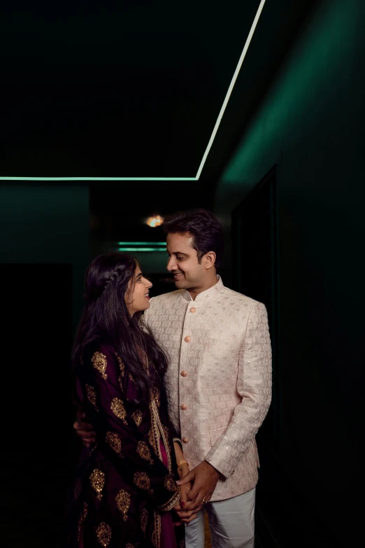 a young couple standing under a ceiling light