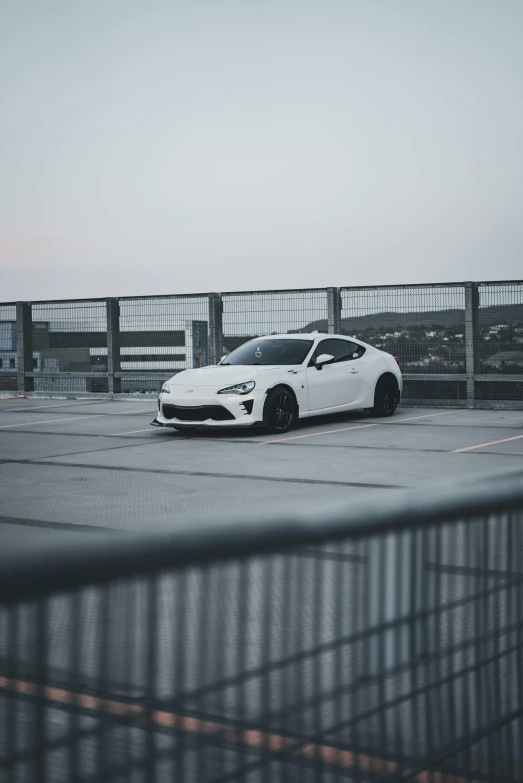 a white sports car parked in an airport