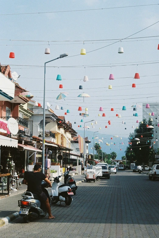 a street is crowded with cars and a man on a motorcycle