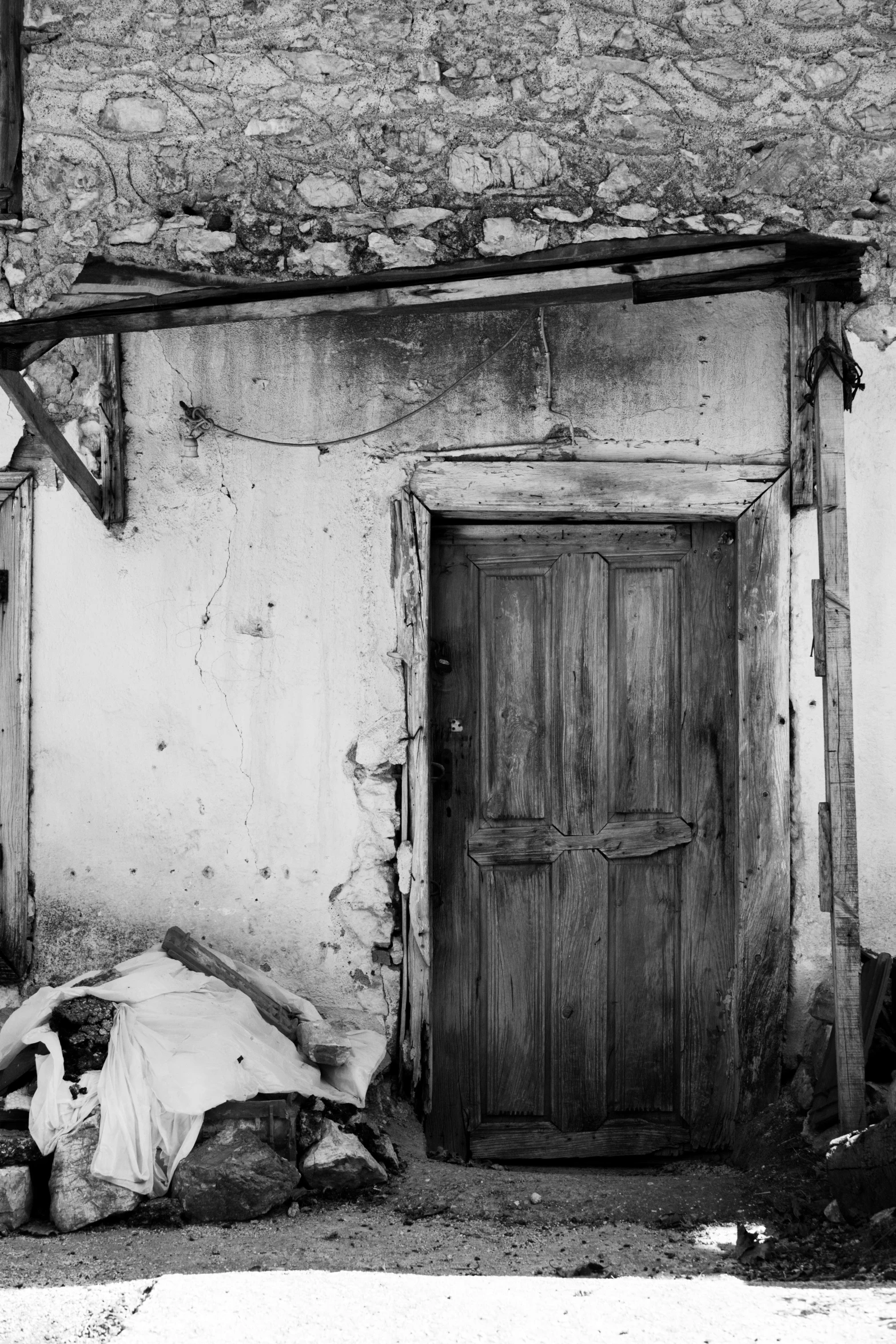 an open door is in between two old doors