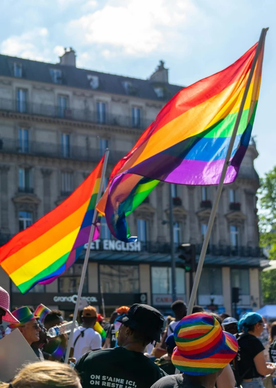 people at a pride event holding rainbow flags