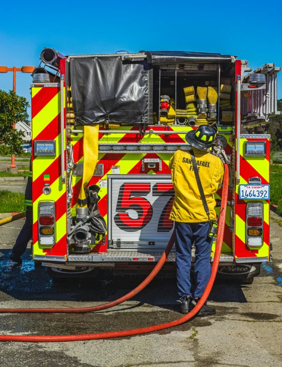 a fireman is pumping his hose into a fire truck