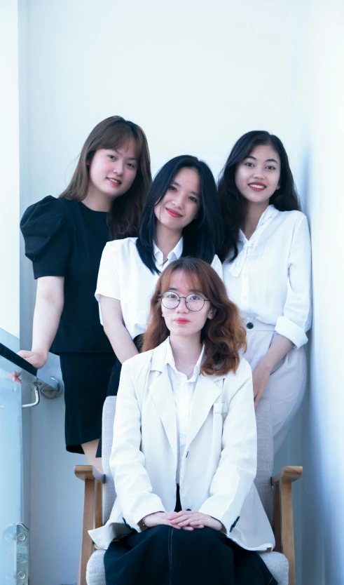 a group of women standing and sitting down