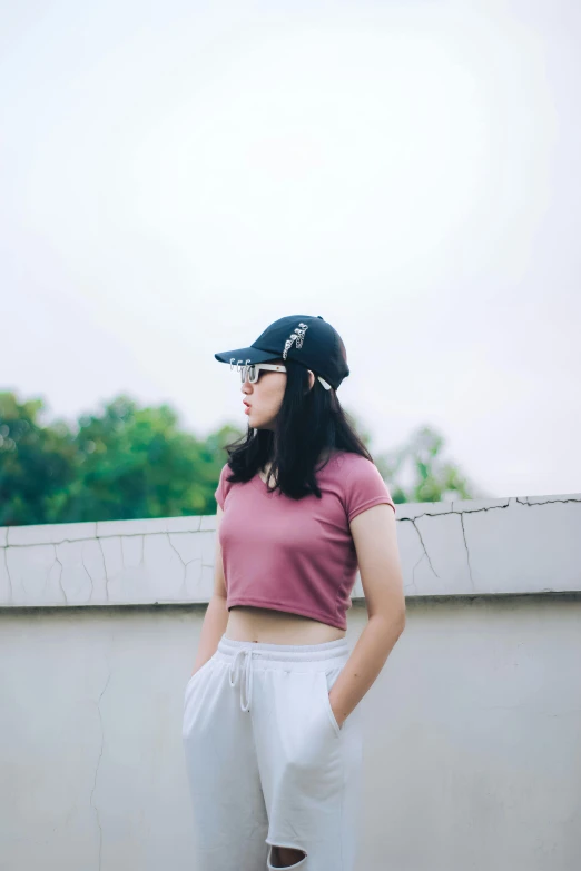 a woman wearing short shorts and a baseball cap