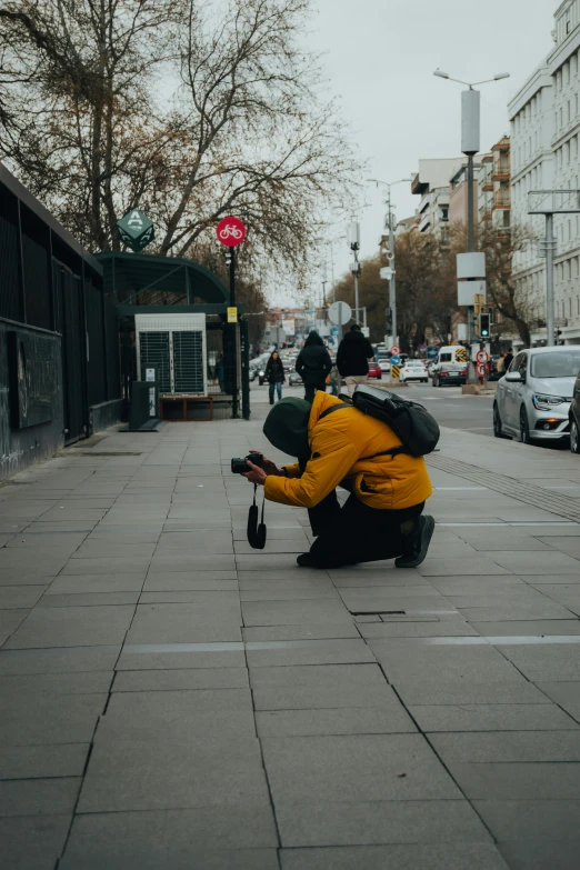 a man kneeling down and holding a snowboard on his hands