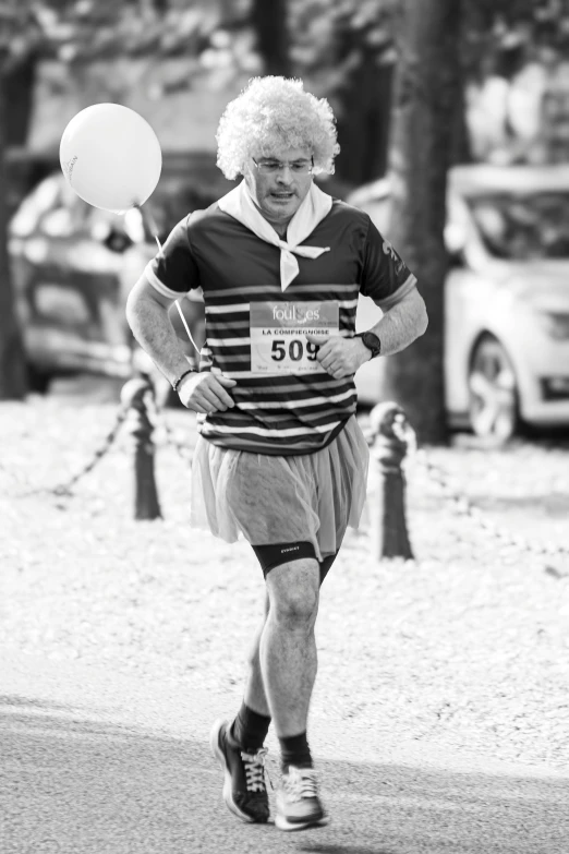 a man running with a balloon behind him