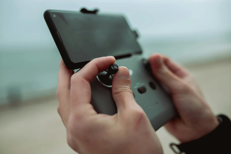 a person holding and operating a video game controller