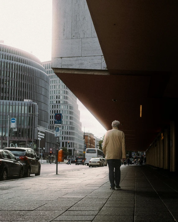 an older man walking down a city street