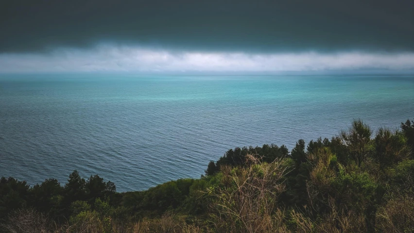 some very pretty dark clouds above some blue water