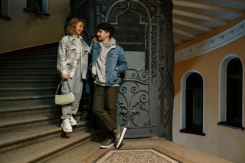 a man and a woman standing on the steps