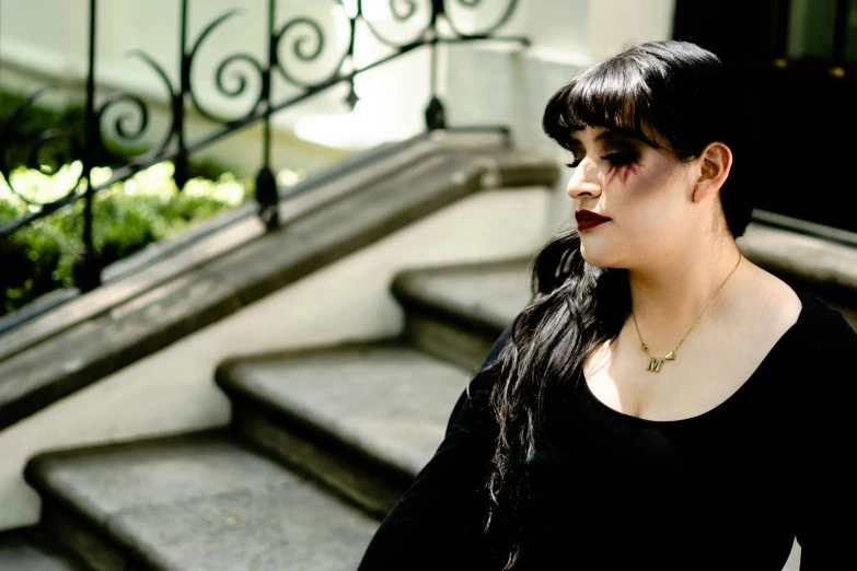 a woman walking down some stairs with her hair in pigtails