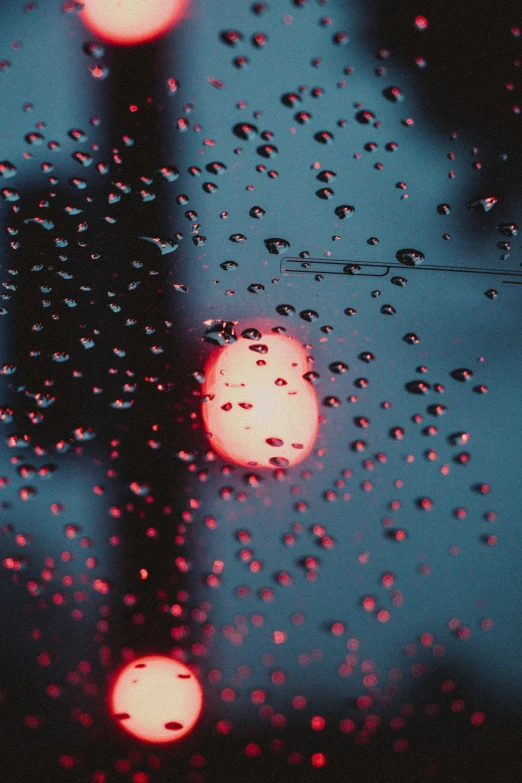 close up s of a rain soaked window and street light