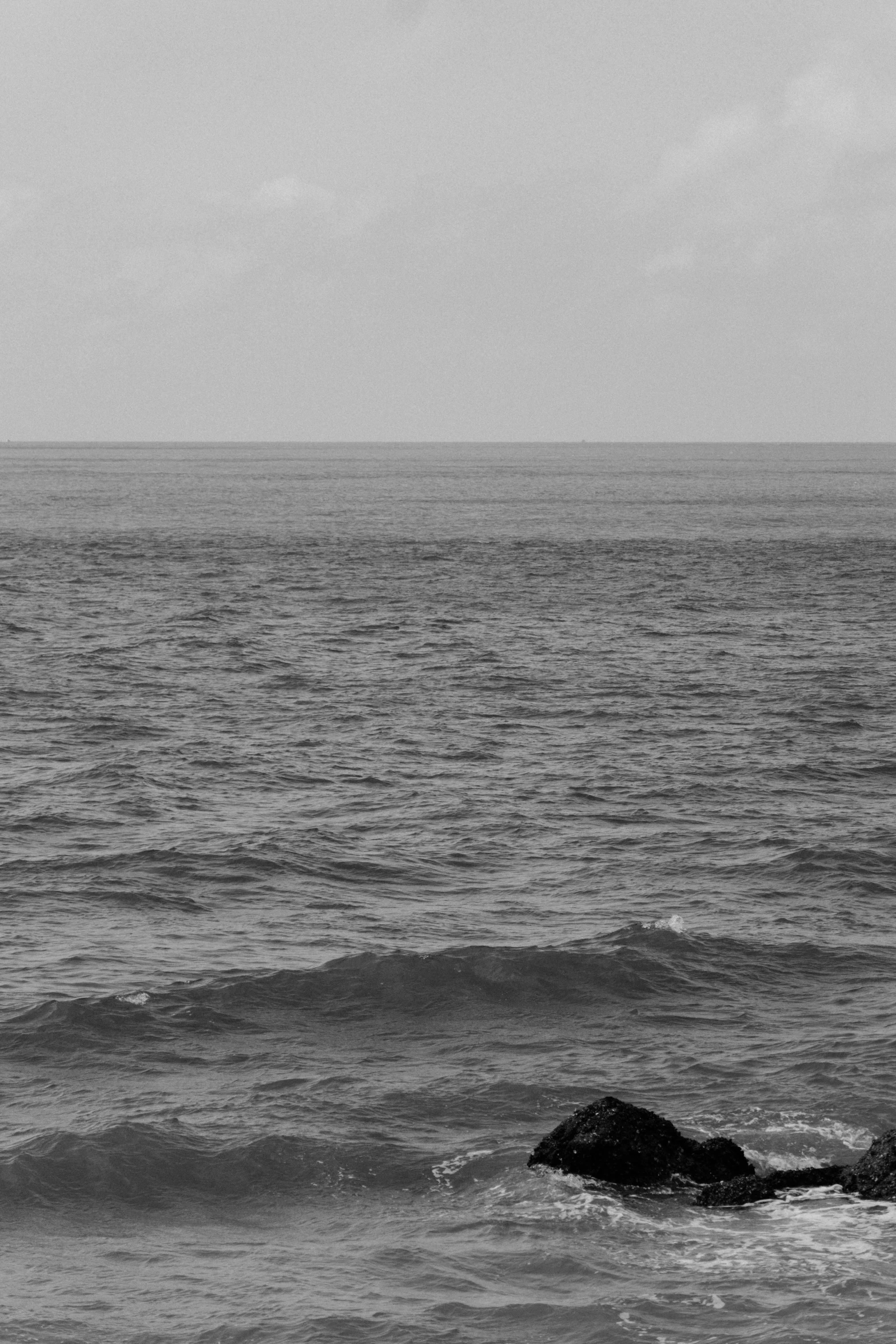 a boat on the ocean with waves coming in