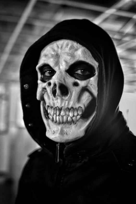 a man with skull painted on his face in the darkness