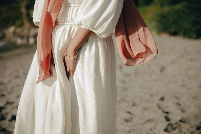 a woman with a hand fan is on the beach