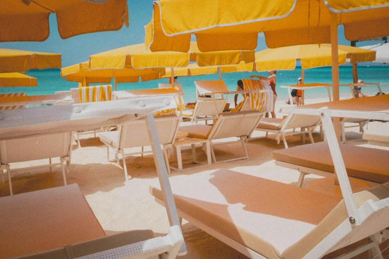 an artistic painting of a beach with chairs and yellow umbrellas