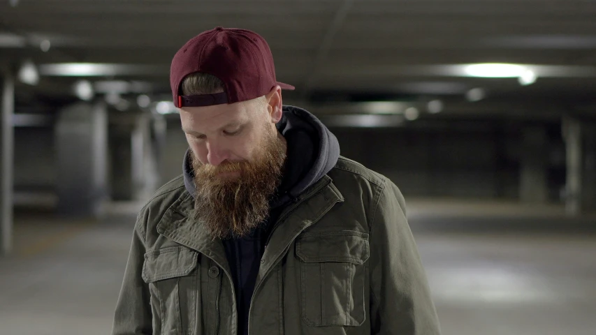 a man with a beard, wearing a red hat and jacket