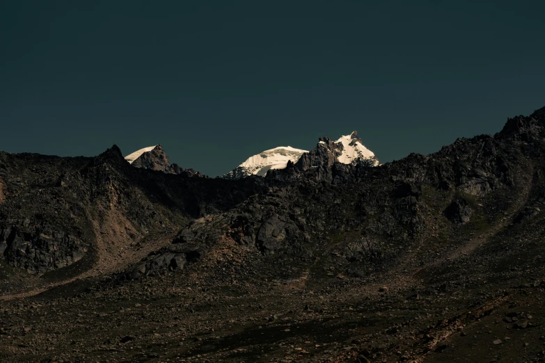 a mountain with some snow on it is dark