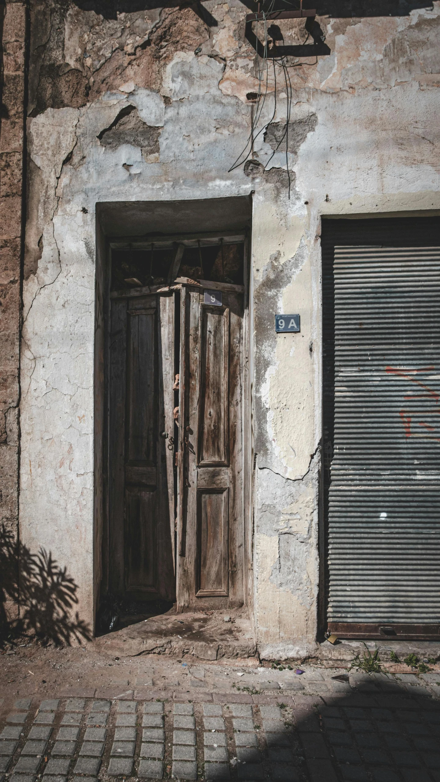 a door to the entrance to a dirty building