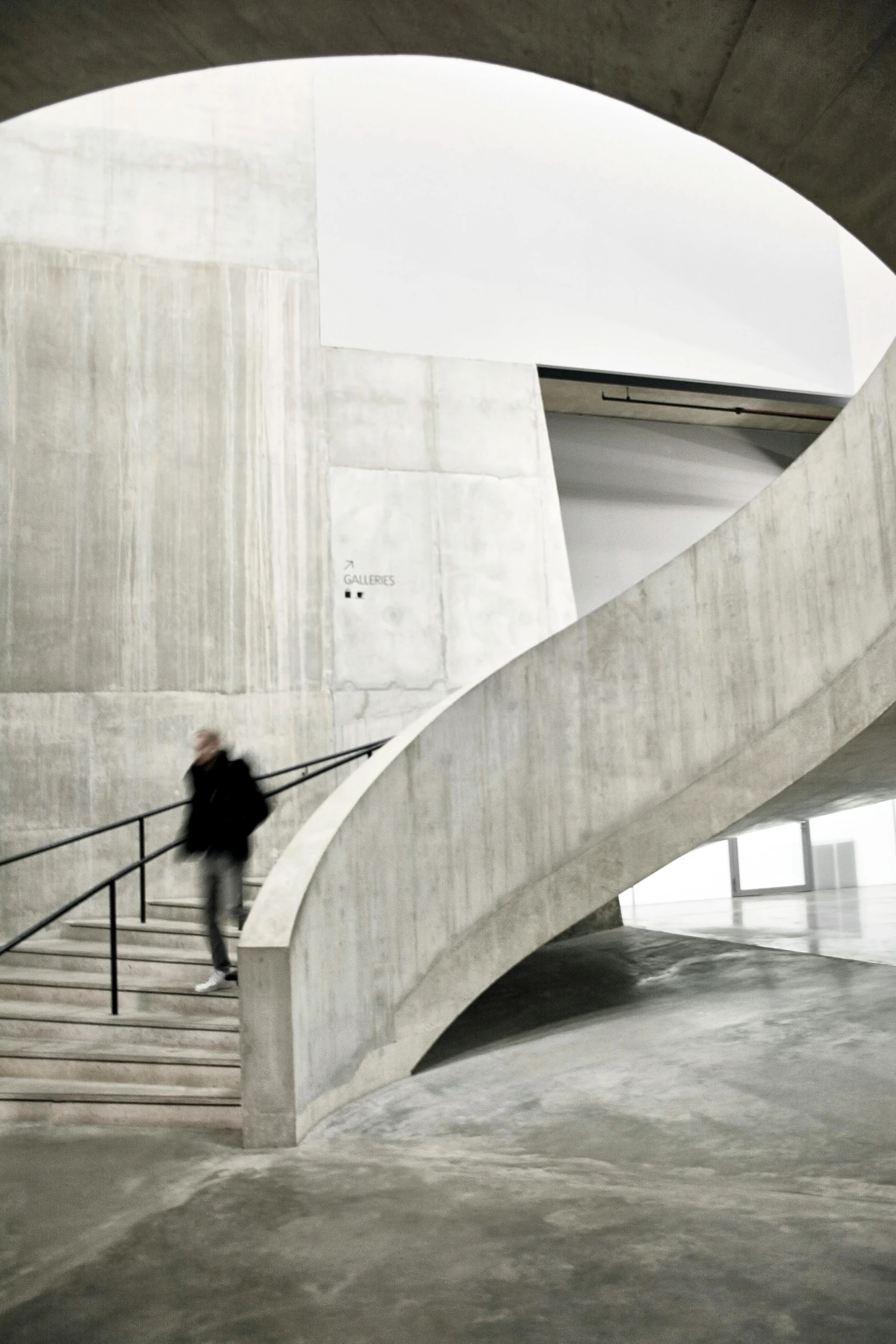 person riding on an escalator up the stairs