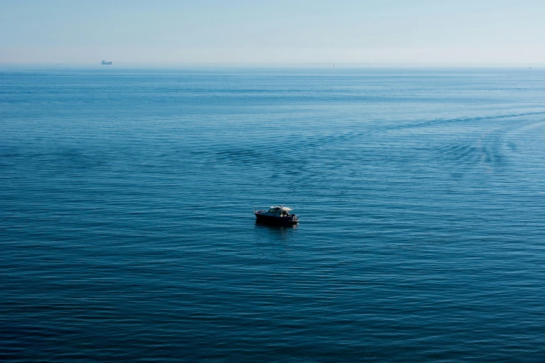 a small boat out on the blue ocean