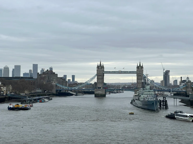 the view of a boat traveling under a suspension bridge