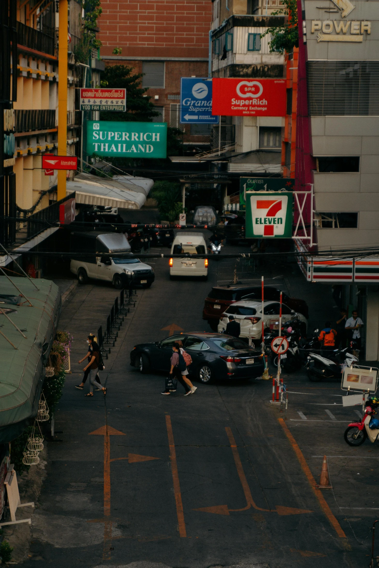 a view of a city with people and cars