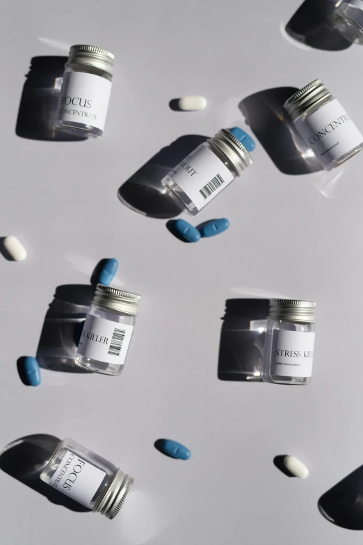 many medicine jars and pills sitting on a table