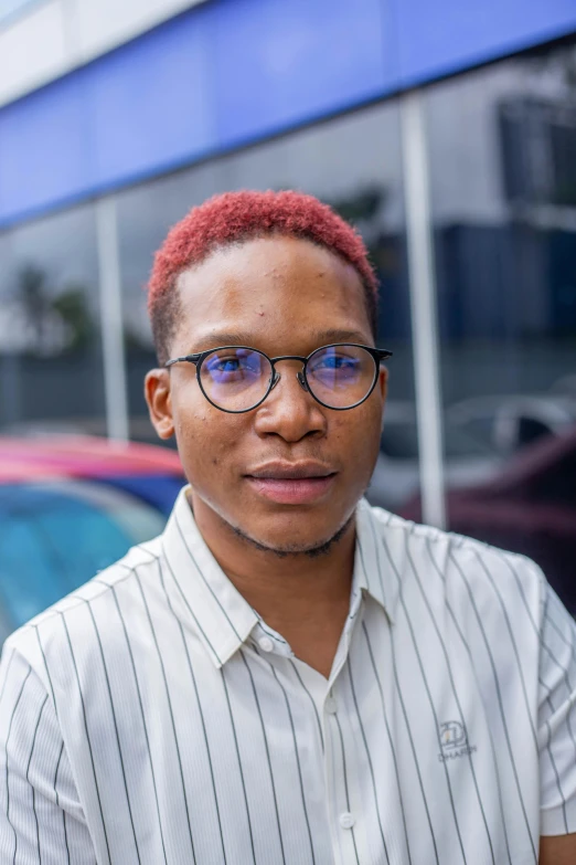 a man is standing outside wearing glasses