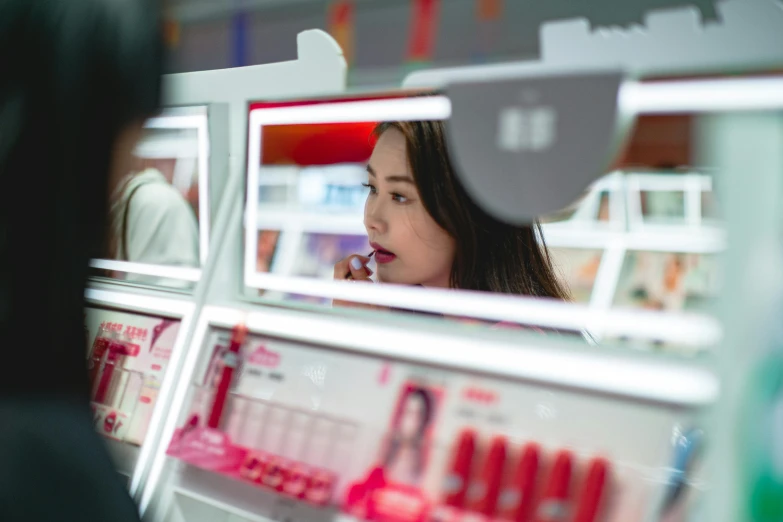 a woman is standing in front of a mirror