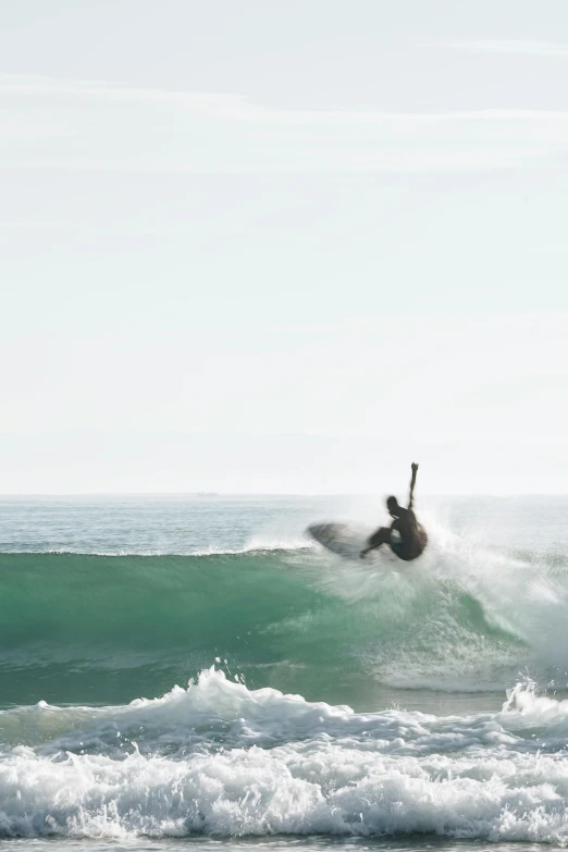 a person rides the waves on a surfboard