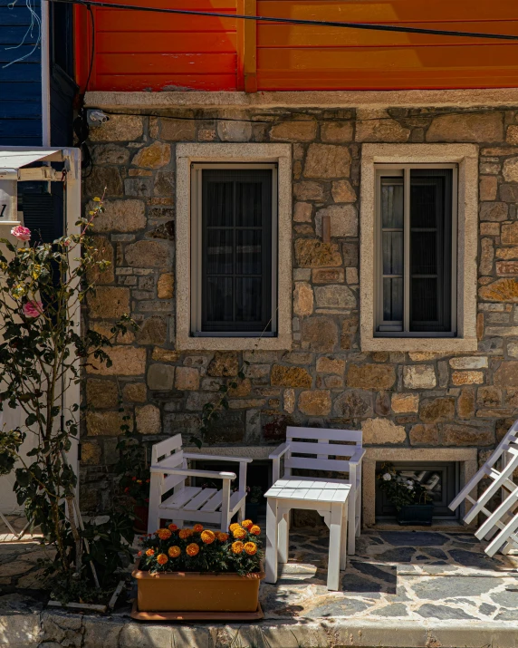 two adironda chairs outside of an old stone building