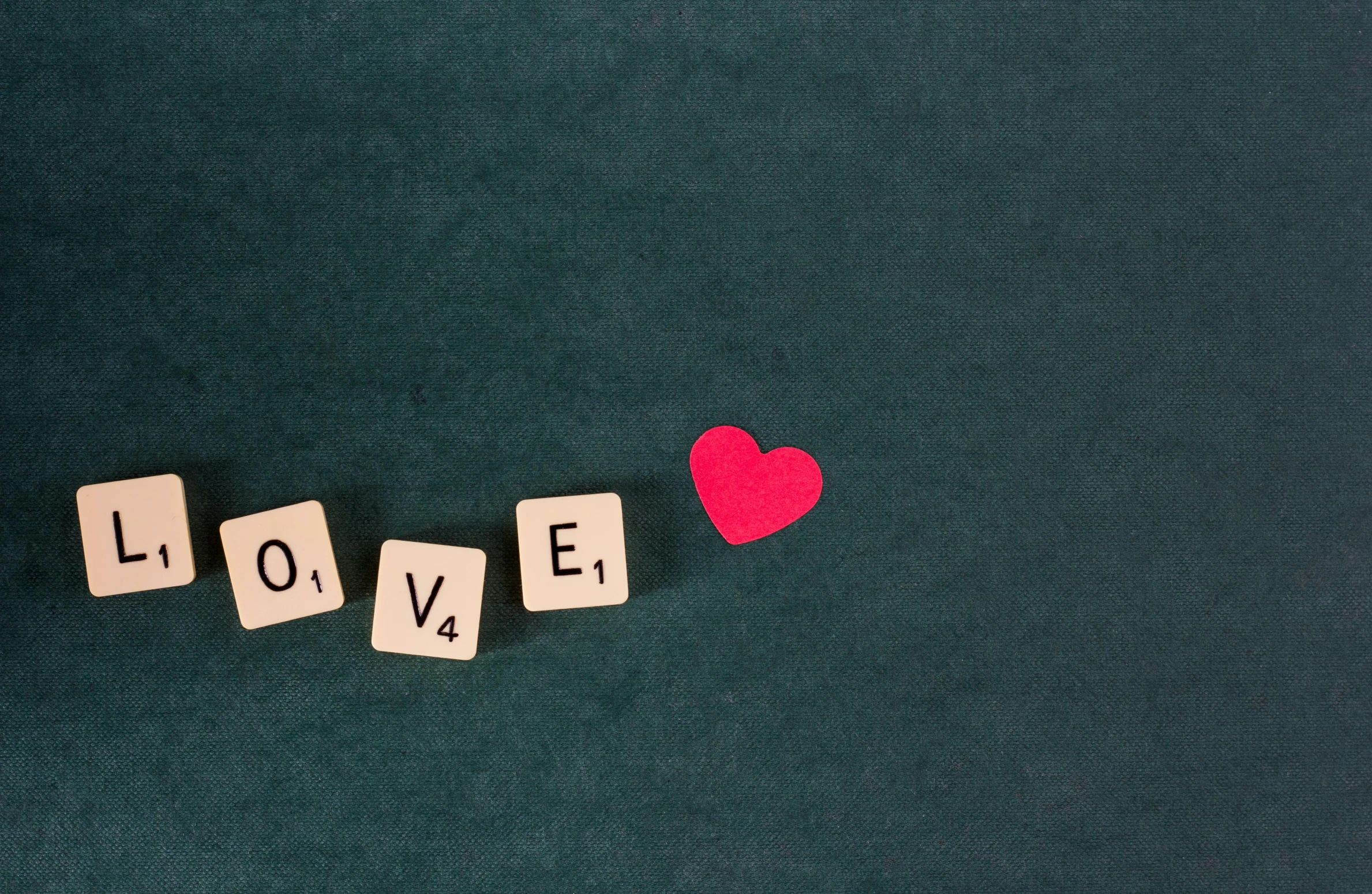 two wooden cubes with the word love spelled in them