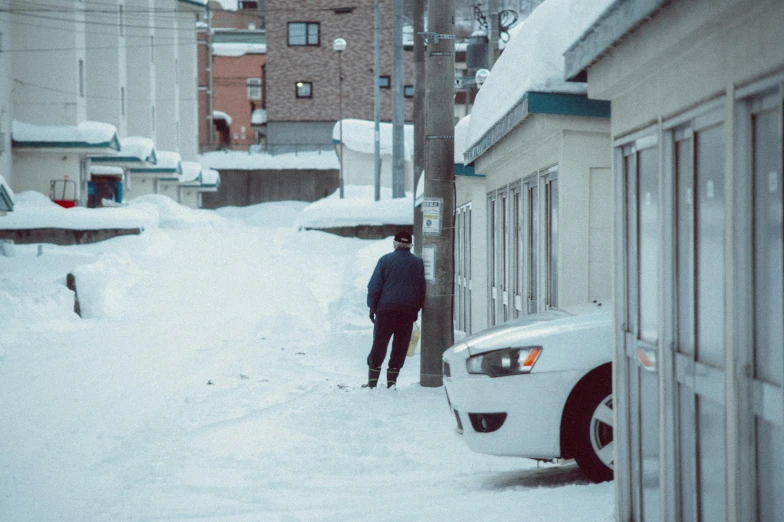 man walking through a neighborhood in the winter