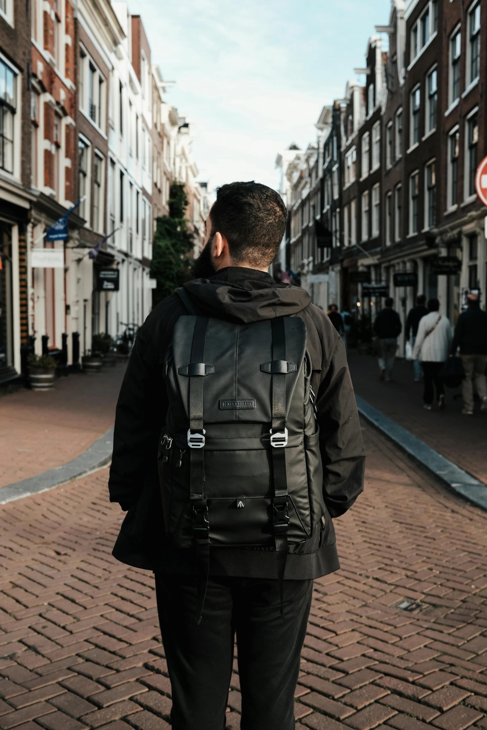 a man with a backpack on a brick road